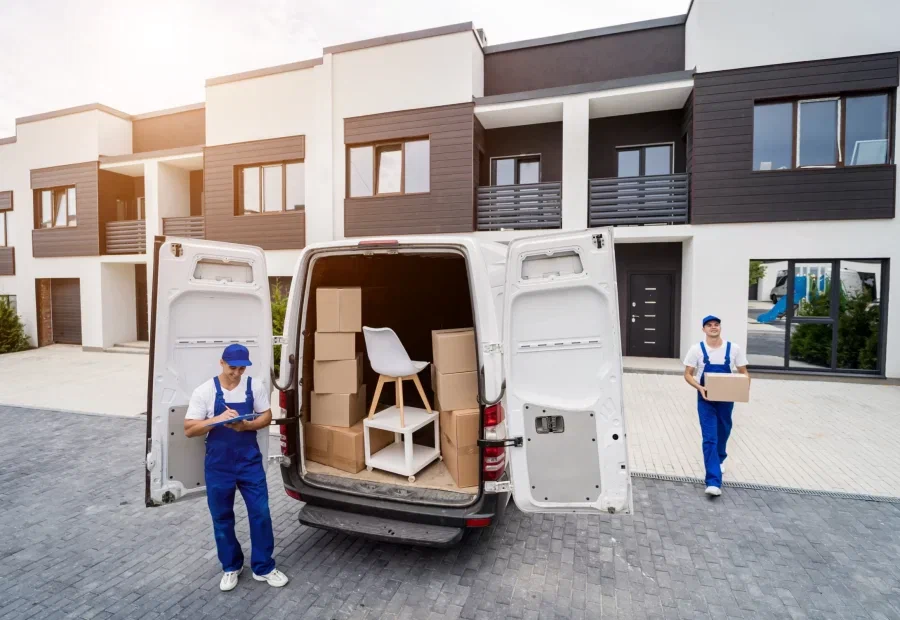 Professional movers unloading boxes from moving van